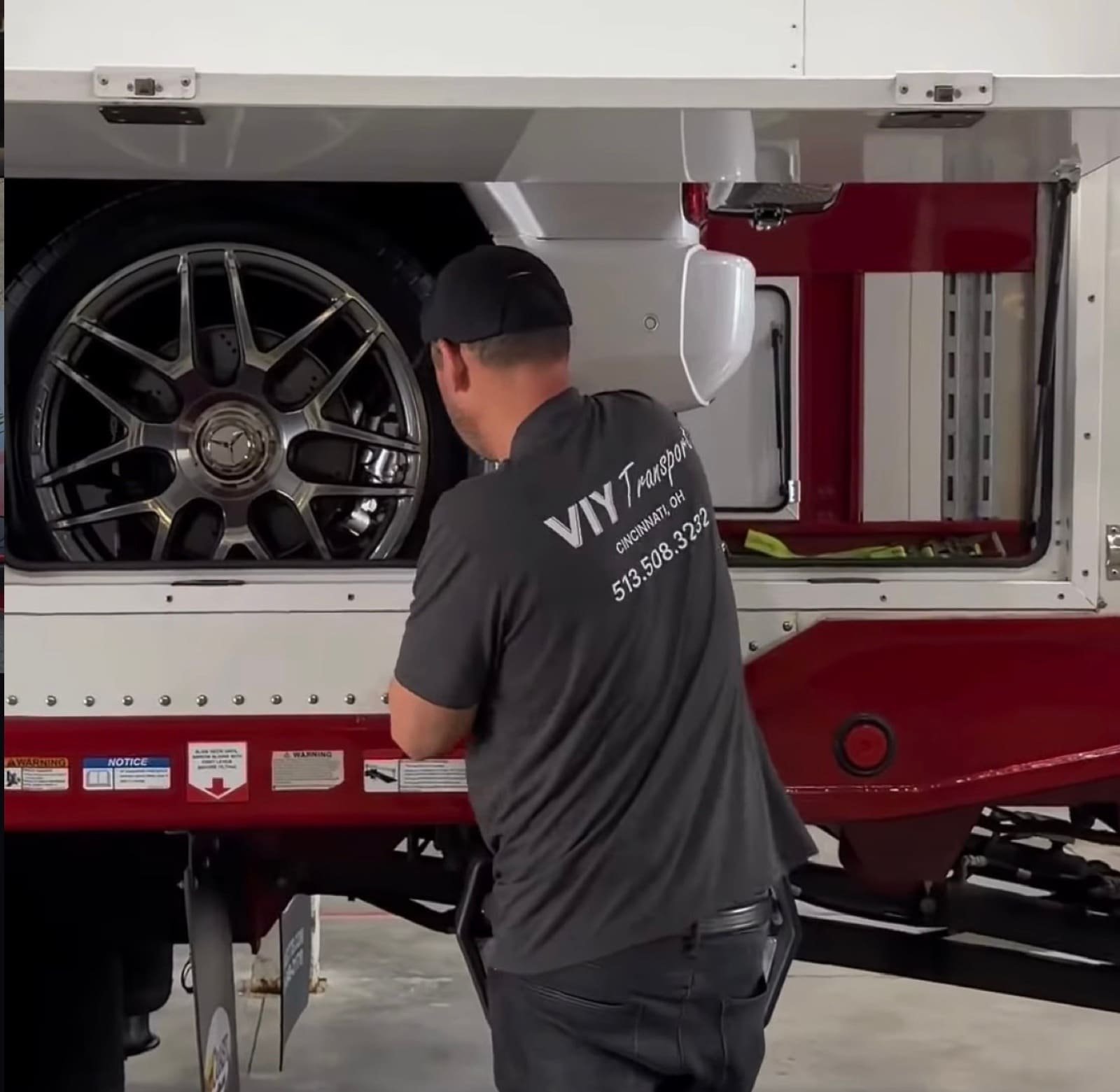 VIY Transport crew member carefully securing a vehicle on the trailer