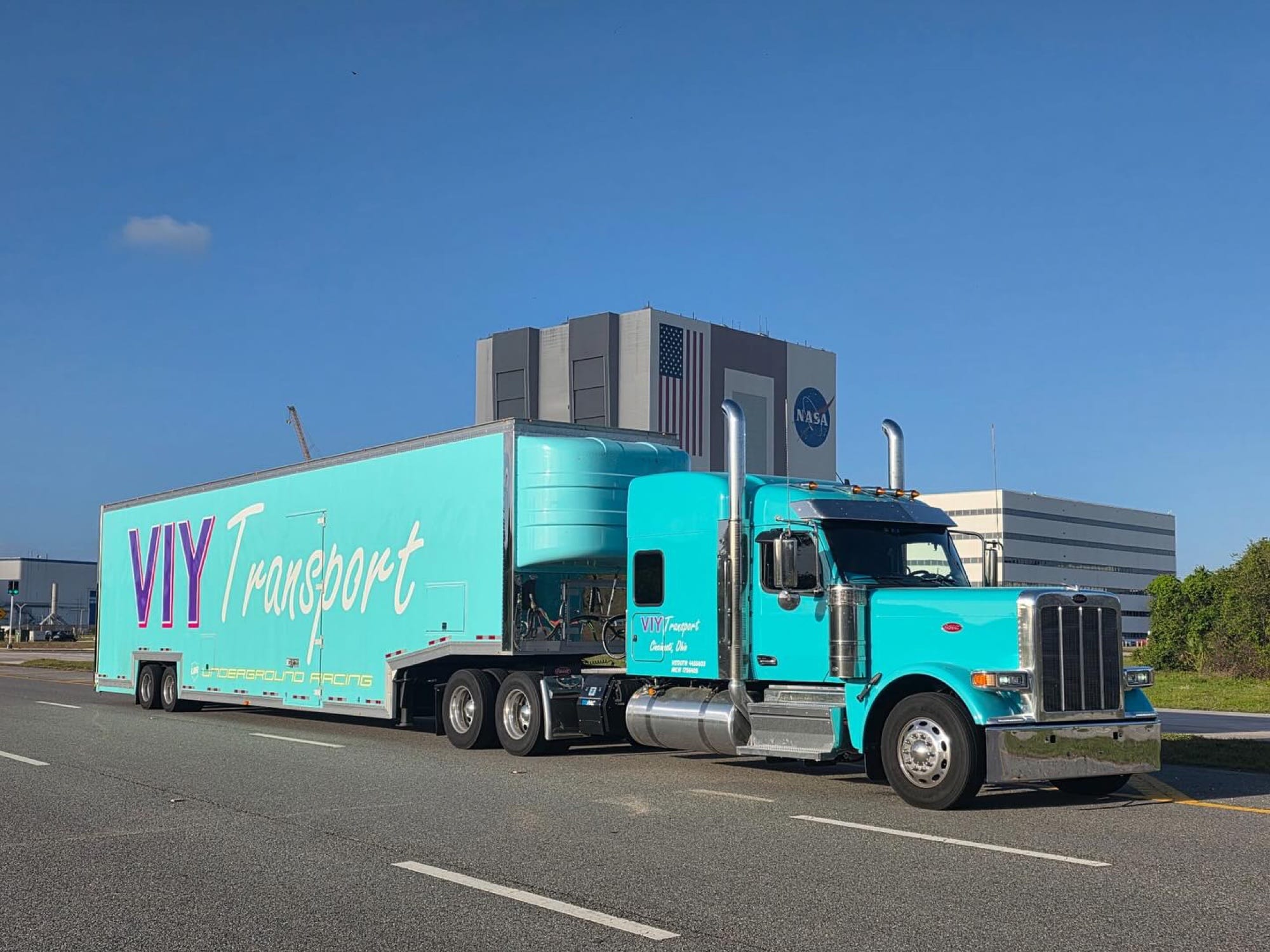 VIY Transport 2026 Peterbilt 589 with six-car enclosed carrier at Kennedy Space Center