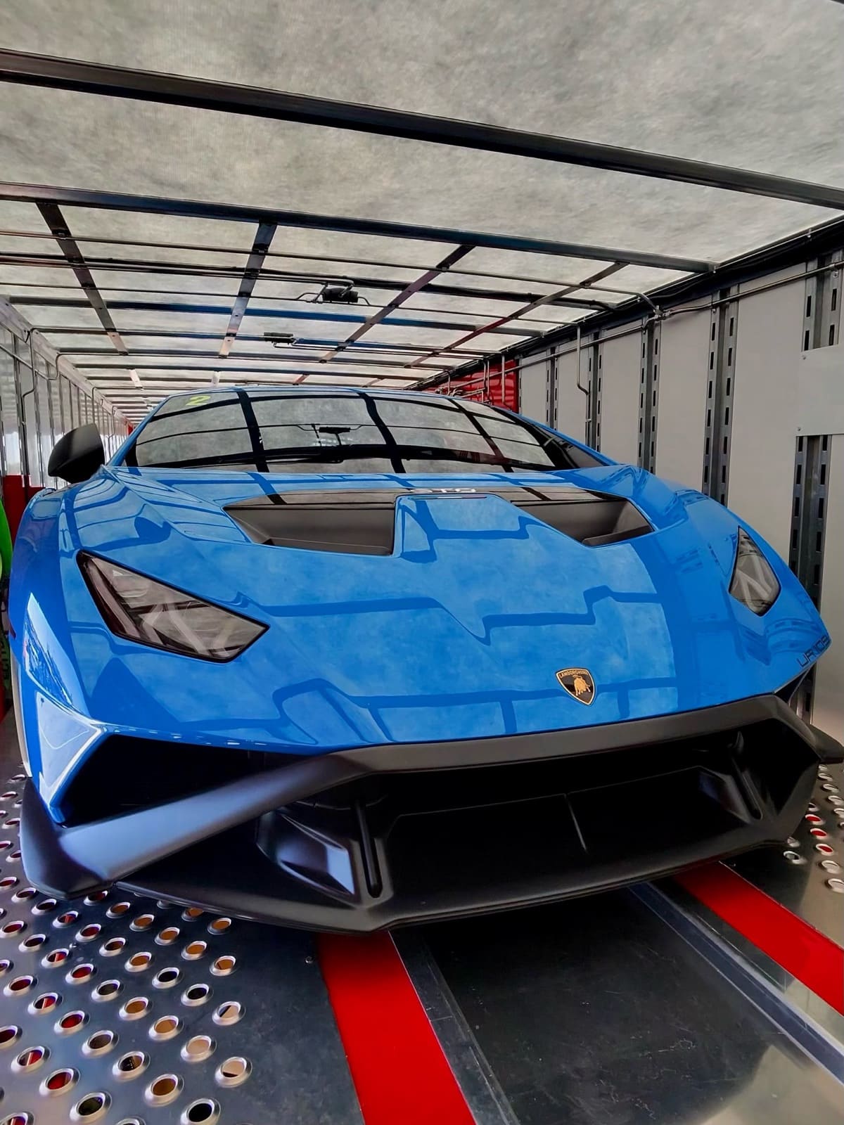 Blue Lamborghini HuracΓ‘n STO loaded inside a VIY Transport enclosed trailer